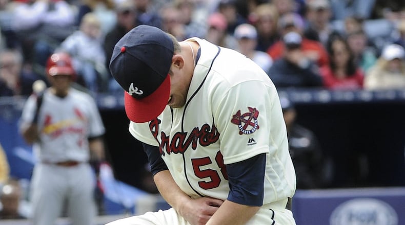 Braves reliever Dan Winkler collapses after fracturing his right elbow throwing a pitch in a game on April 10, 2016. (AP Photo/John Amis)