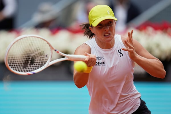 Iga Swiatek of Poland returns the ball against United States' Madison Keys during the Madrid Open tennis tournament in Madrid, Spain, Wednesday, April 30, 2025. (AP Photo/Manu Fernandez)