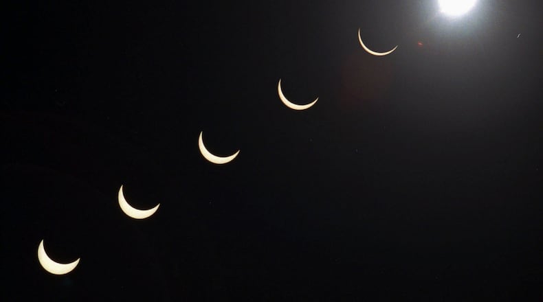 FILE - The progression of a total solar eclipse is seen in a multiple exposure photograph taken in 5-minute intervals, with the moon passing in front of the sun above Siem Reap in northwestern Cambodia, 225 kilometers (140 miles) from Phnom Penh, on Tuesday, Oct. 24, 1995. (AP Photo/Richard Vogel, File)