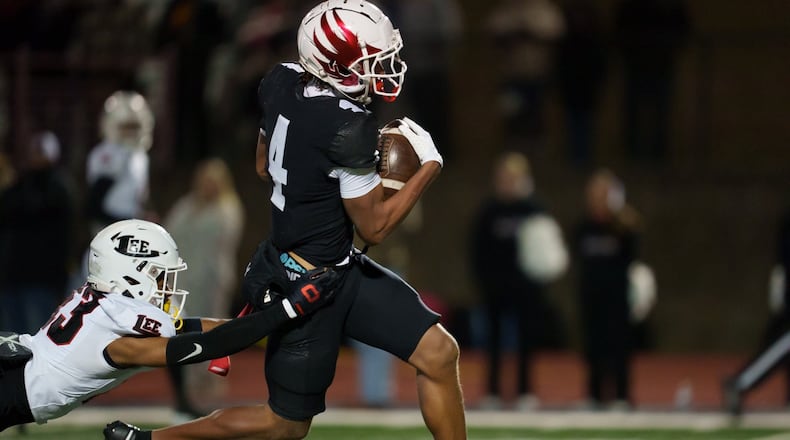 Milton's C.J. Wiley carries the ball against Lee County in a GHSA Class 5A state semfinal game Dec. 6, 2024 at Milton. (JSM Productions)