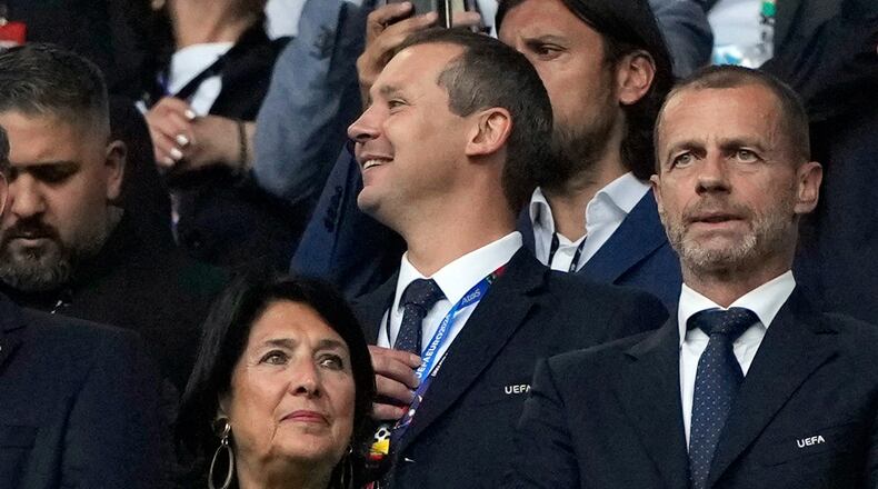 FILE - UEFA's deputy general secretary Kevin Lamour, centre, looks on as he stands next to UEFA President Aleksander Ceferin, right, prior to the start of a Group F match between Turkey and Georgia at the Euro 2024 soccer tournament in Dortmund, Germany, Tuesday, June 18, 2024. K(AP Photo/Alessandra Tarantino, File)