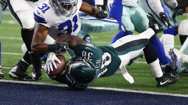Philadelphia Eagles running back Kenjon Barner (38) scores a first quarter touchdown against Dallas Cowboys safety Byron Jones (31) at AT&T Stadium.