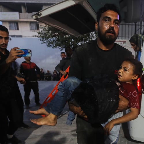 A Palestinian man carries a wounded girl into al-Shifa Hospital following Israeli strikes on the Gaza Strip, Saturday, Nov. 22, 2025. (AP Photo/Yousef Al Zanoun)