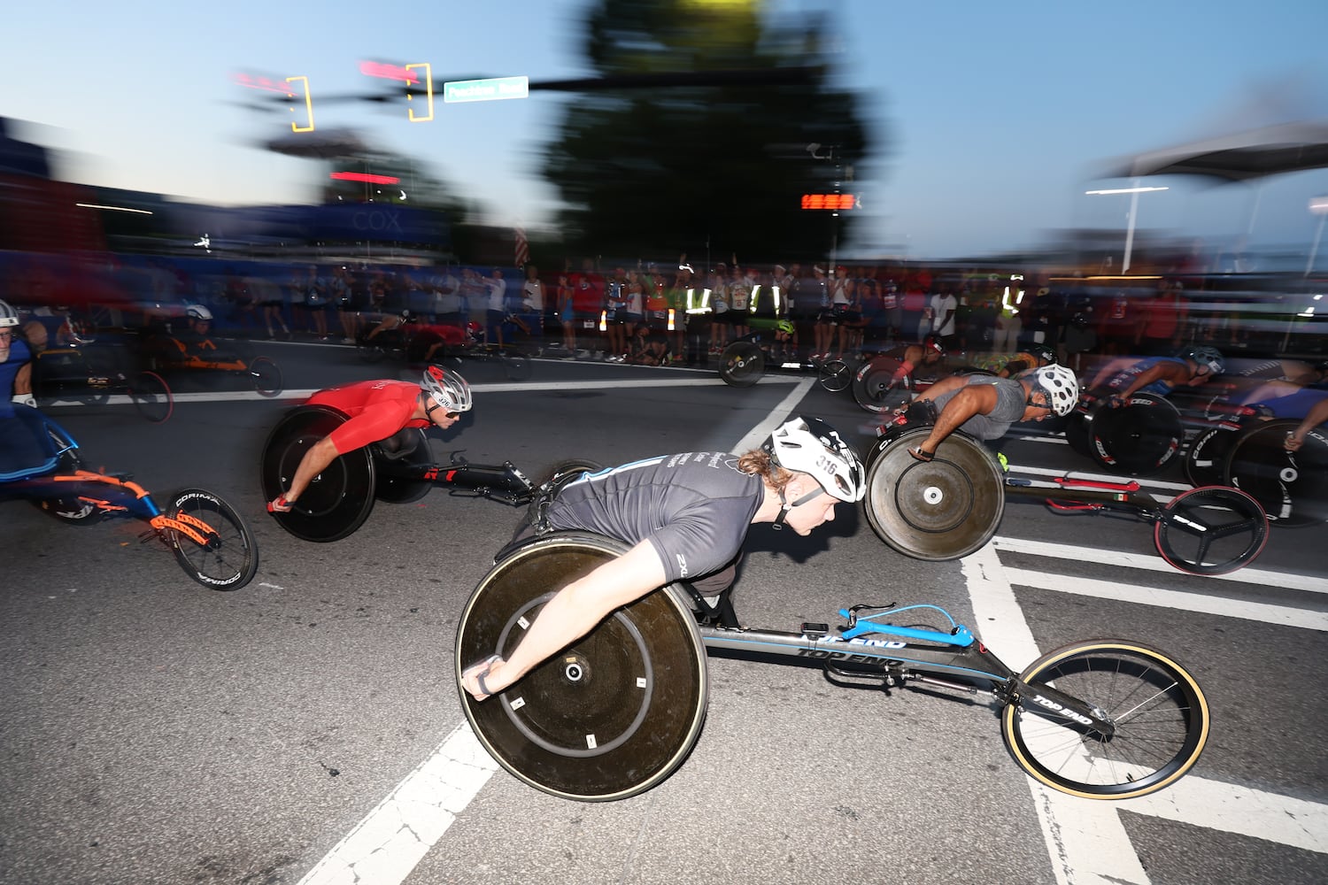 Men’s wheelchair division starts the 55th running of the Atlanta Journal-Constitution Peachtree Road Race in Atlanta on Thursday, July 4, 2024.   (Miguel Martinez / Miguel Martinez / AJC)