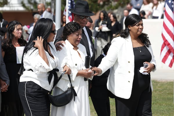 Marie Lourdes Love, center, walks with Maxum Love, behind, during the memorial service of their daughter, former U.S. Rep. Mia Love, at The Church of Jesus Christ of Latter-day Saints on the University of Utah campus in Salt Lake City, Monday, April 7, 2025. (AP Photo/Melissa Majchrzak)