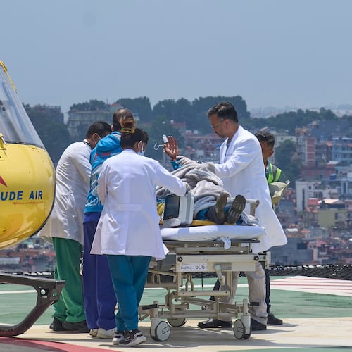 Medics take Dawa Sherpa, a mountain guide who had been missing for several days in the Everest region, for treatment after he arrived at Grande Hospital in Kathmandu, Nepal, Thursday, June 4, 2026. (AP Photo/Niranjan Shrestha)