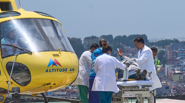 Medics take Dawa Sherpa, a mountain guide who had been missing for several days in the Everest region, for treatment after he arrived at Grande Hospital in Kathmandu, Nepal, Thursday, June 4, 2026. (AP Photo/Niranjan Shrestha)
