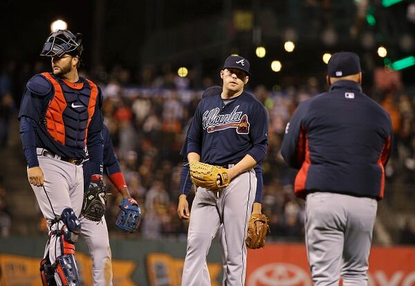 Atlanta Braves relief pitcher Brandon Cunniff, center, stands on the mound as manager Fredi Gonzalez, right, comes out to remove him during the eighth inning of the Braves' baseball game against the San Francisco Giants on Thursday, May 28, 2015, in San Francisco. At left is catcher A.J. Pierzynski. (AP Photo/Eric Risberg)