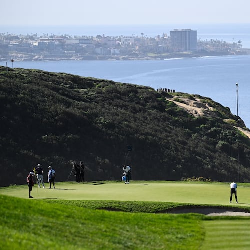 FILE - Justin Rose, of England, putts on the third green of the South Course at Torrey Pines during the final round of the Farmers Insurance Open golf tournament, Feb. 1, 2026, in San Diego. (AP Photo/Denis Poroy, file)