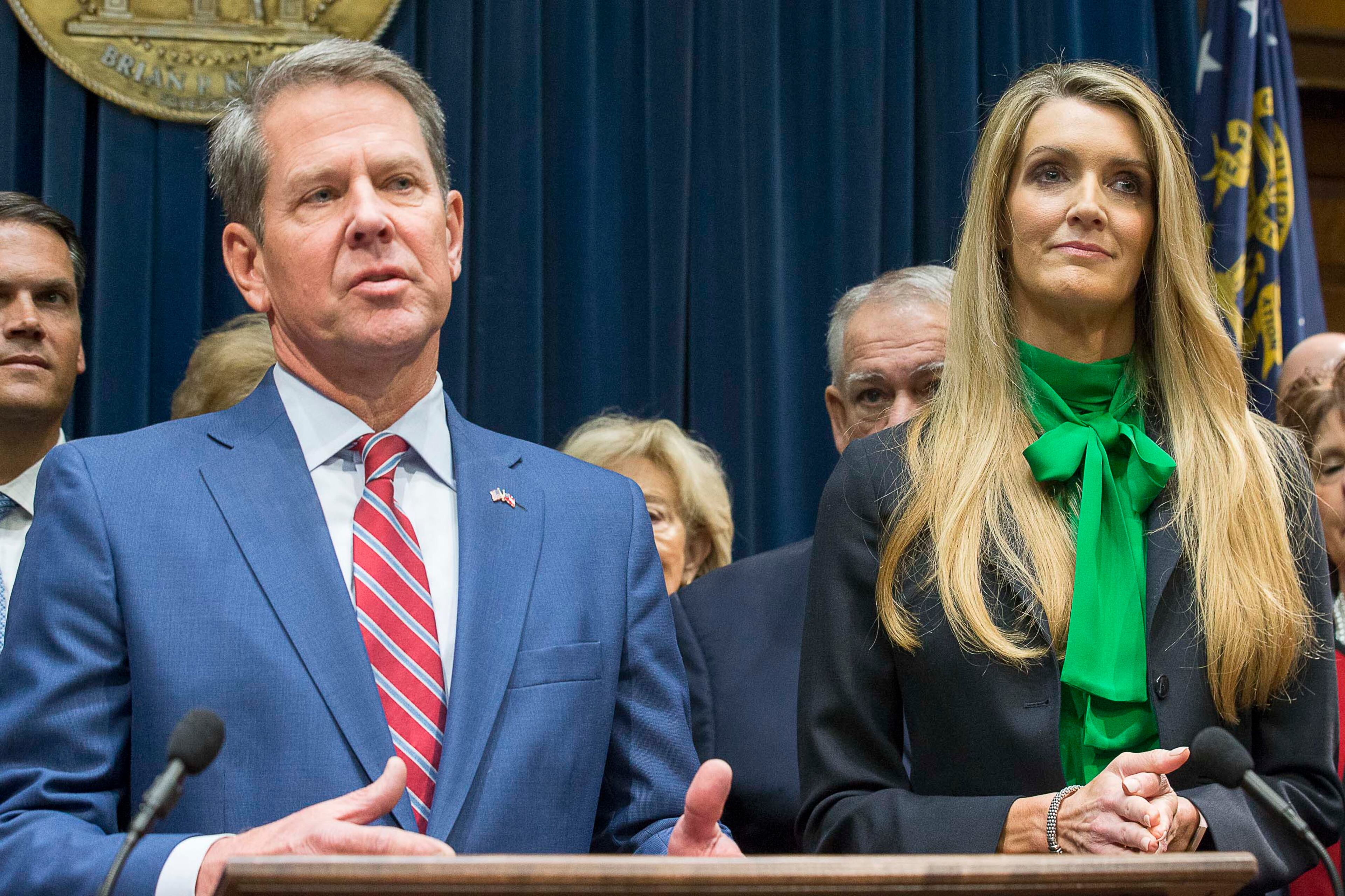 Newly appointed U.S. Sen. Kelly Loeffler (right) listens as Georgia Gov. Brian Kemp (left) speaks during a press conference in his office at the Georgia State Capitol Building, Wednesday, December 4, 2019. (Alyssa Pointer/AJC)