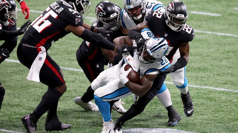 Atlanta Falcons safety Keanu Neal (22) and teammates tackle Carolina Panthers running back Mike Davis (28) in the first quarter on Sunday, Oct. 11, 2020 at Mercedes-Benz Stadium in Atlanta, Georgia. (Jason Getz/Atlanta Journal-Constitution/TNS)