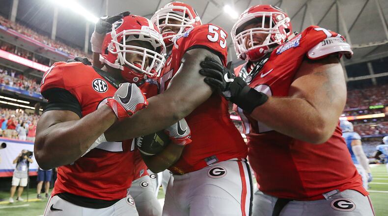 Georgia tail back Nick Chubb (from left) celebrates his touchdown for a 33-24 lead over North Carolina with Dyshon Sims and Tyler Catalina in the Chick-fil-A Kickoff Game on Saturday, Sept. 3, 2016, in Atlanta.