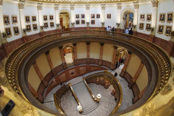 As viewed through a fisheye lens, the rotunda where portraits of presidents are displayed except for Donald Trump is shown after the picture was removed from the wall of the rotunda in the State Capitol following complaints about the likeness from Trump Tuesday, March 25, 2025, in Denver. (AP Photo/David Zalubowski)