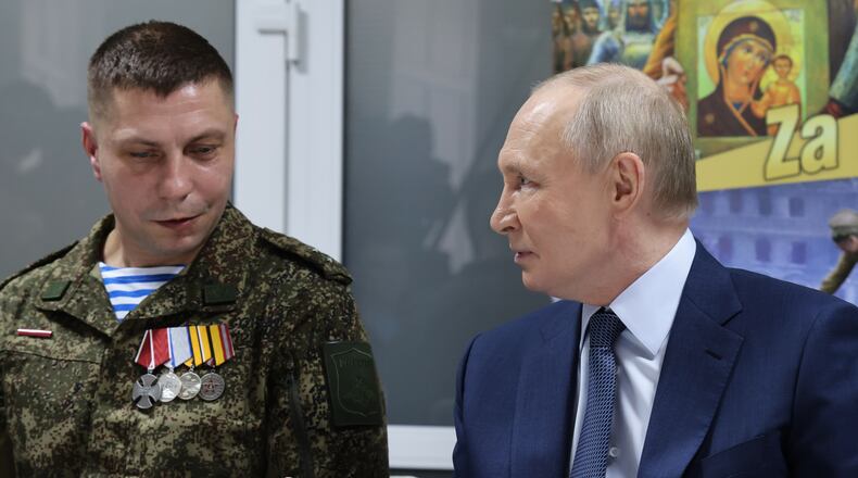 Russian President Vladimir Putin, right, talks with Russian servicemen who fought in Ukraine as he visits the Central Military Clinical Hospital, in Moscow, Russia, Wednesday, Oct. 29, 2025. (Vladimir Gerdo, Sputnik, Kremlin Pool Photo via AP)