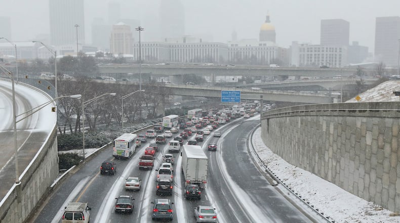 Jan. 24, 2014 Atlanta: Nortbound connector traffic - frozen. The winter storm that paralyzed metro Atlanta and other parts of Georgia prompted Gov. Nathan Deal to declare a state of emergency Tuesday afternoon, Jan.28, 2014 for all 159 counties. In a matter of hours, snow blanketed the area. But any hopes of a winter wonderland were dashed by a more miserable reality. Take rush-hour traffic in Atlanta, add inches of slushy, slick mess and the result is gridlock on interstates in all directions. For hours, roads and interstates have remained jammed stranding some drivers, and there were too many wrecks to count Tuesday afternoon as a winter storm continued to dump snow across metro Atlanta. Many school systems dismissed early, sending some parents scrambling home. Others seemed to hit the roads, too. But it was anything but a typical commute, even by Atlanta standards. Drivers reported commutes of more than three hours. Some school buses couldn't run routes and were forced to return to schools. And teachers and students were faced Tuesday afternoon with the real possibility of spending the night in the classroom. JOHN SPINK/JSPINK@AJC.COM