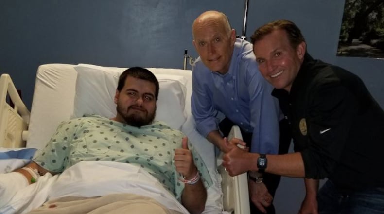 Jacksonville "Madden" mass shooting victim Timothy Anselmo in UF Health Jacksonville with Gov. Rick Scott of Florida and Jacksonville Mayor Lenny Curry.