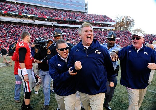 Georgia Tech head coach Paul Johnson, center, shouts and clenches his fist after Georgia quarterback Hutson Mason (14) threw an interception to Tech's D.J. White during overtime to preserve a 30-24 win in an NCAA college football game Saturday, Nov. 29, 2014, in Athens, Ga. (AP Photo/David Tulis) "How 'bout that high school offense!" (David Tulis/AP photo)