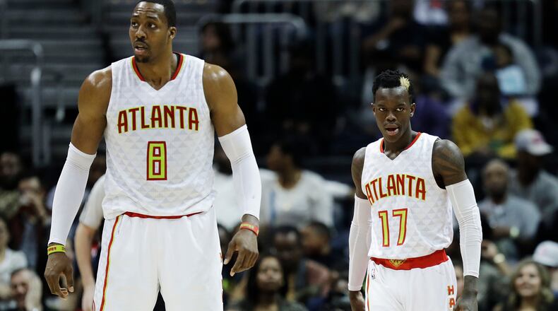 Atlanta Hawks’ Dennis Schroder and teammate Dwight Howard stand on the court in the fourth quarter of an NBA basketball game against the Brooklyn Nets in Atlanta, Wednesday, March 8, 2017. (AP Photo/David Goldman)