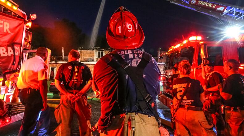 DeKalb County’s government might not have been eligible for the $150,000 it collected from the federal government to hire 34 firefighters, according to a report by DeKalb Ethics Officer Stacey Kalberman. In this July 11 photo, DeKalb firefighters combat a massive fire that tore through part of an apartment building and displaced 19 people along Shallowford Road. JOHN SPINK/JSPINK@AJC.COM.