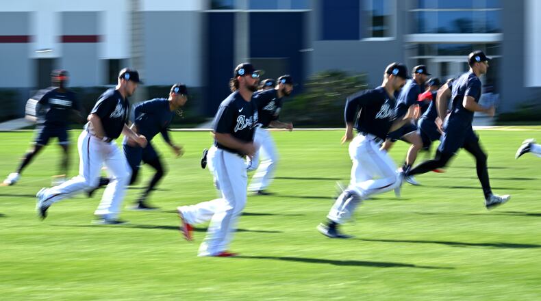 Atlanta Braves players warm up during Braves spring training at CoolToday Park, Saturday, Feb. 18, 2023, in North Port, Fla.. (Hyosub Shin / Hyosub.Shin@ajc.com)