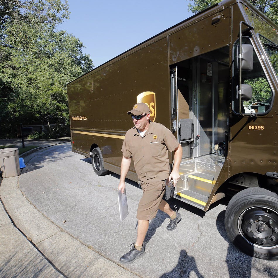 UPS driver Dan Partyka delivers an overnight package. As more people buy more goods online, the rapid and unrelenting expansion of e-commerce is causing real challenges for the Sandy-Springs based company. (Bob Andres/AJC 2022)