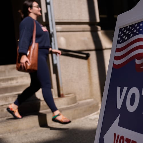 A sign directs voters to an entrance for City Hall during early voting for the Rhode Island primary election, Wednesday, Sept. 2, 2026, in Providence, R.I. (AP Photo/David Goldman)
