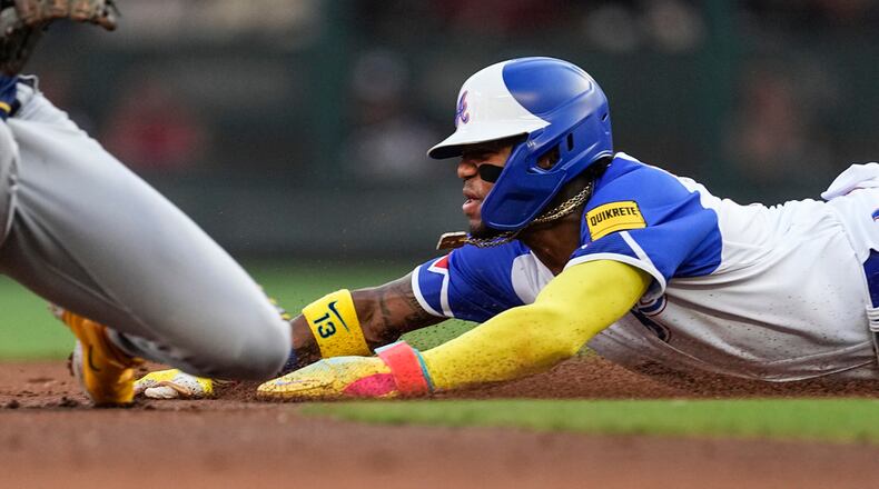 Atlanta Braves' Ronald Acuna Jr. steals second base during the first inning of the team's baseball game against the Milwaukee Brewers on Saturday, July 29, 2023, in Atlanta. (AP Photo/John Bazemore)