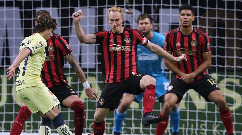 August 14, 2019 Atlanta: Atlanta United captain Jeff Larentowicz (center) and MIles Robinson (right) defend the goal against Club America midfielder Sebastian Cordova in the Campeones Cup on Wednesday, August 14, 2019, in Atlanta. Curtis Compton/ccompton@ajc.com