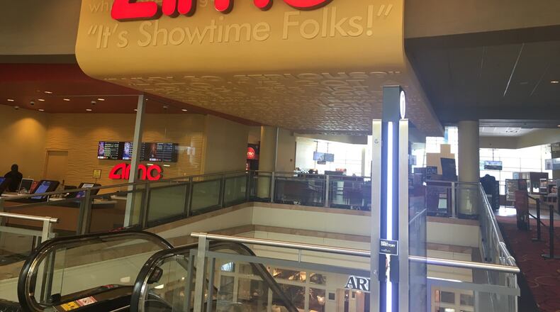 A balloon display being popped outside a theater at the AMC Phipps Plaza 14 on Saturday morning scared movie-goers into thinking there was an active shooting.