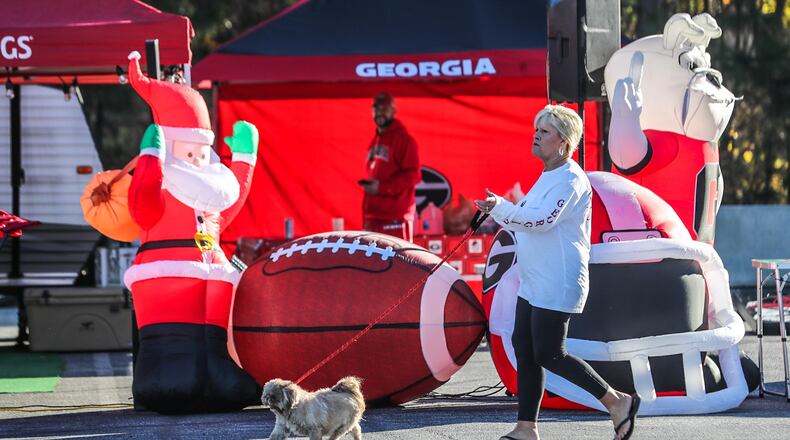 Thomaston resident Janet Pitts walks her dog Annie in the sunshine Friday at the Marshalling Yard at the Georgia World Congress Center.