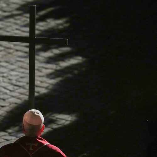 Pope Leo XIV carries a lightweight, 1.5-meter (5-foot) wooden cross during the Via Crucis, the torchlit Good Friday Stations of the Cross procession at the Colosseum in Rome, Friday, April 3, 2026, which symbolically retraces Jesus Christ's steps to his crucifixion on Calvary in Jerusalem. (AP Photo/Alessandra Tarantino)