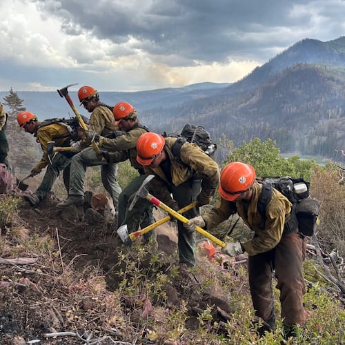 This undated image provided by the U.S. Forest Service Friday, June 26, 2026, shows firefighters responding to the Cottonwood Fire on Wednesday, June 24, 2026, above Birch Lake, near Beaver, Utah. (Mike McMillan/U.S. Forest Service via AP)