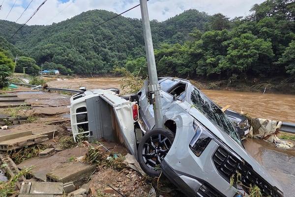 Damaged vehicles are seen after heavy rains in Gapyeong, South Korea, Sunday, July 20, 2025. (Shim Min-kyu/Yonhap via AP)