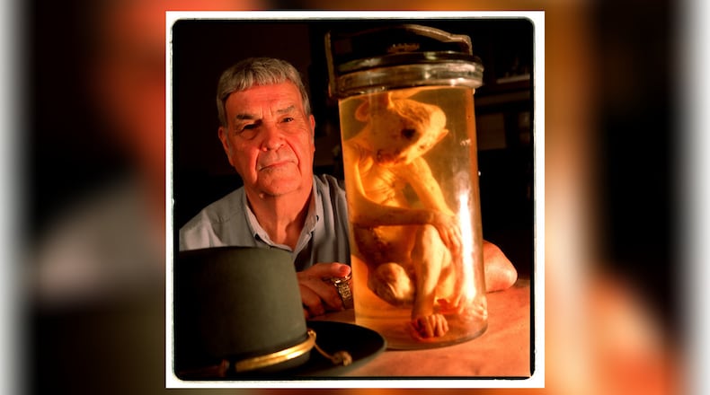 In this July 1998 photo, Sherley Brown, a former Cobb County police colonel, poses with the shaved monkey that was part of a alien hoax in 1953. Brown and his partner were first on the scene, and for a day, the world believed that an alien was discovered in Atlanta. (AJC file photo: Rich Addicks)