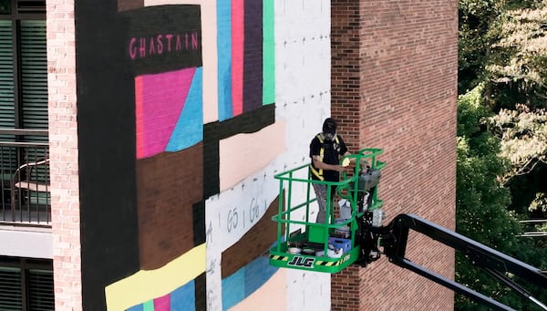Clark used a boom lift to paint the 4,000-square-foot mural on the side of the eight-story high-rise. (Credit: DV Photo Video)