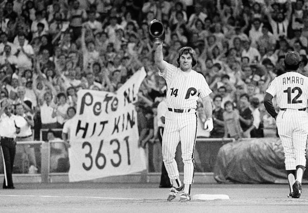 FILE - Philadelphia Phillies' Pete Rose waves while standing on first base after breaking the National League's all-time career hitting record in the eighth inning of baseball game against the St. Louis Cardinals, Monday, Aug. 10, 1981, in Philadelphia. (AP Photo/File)