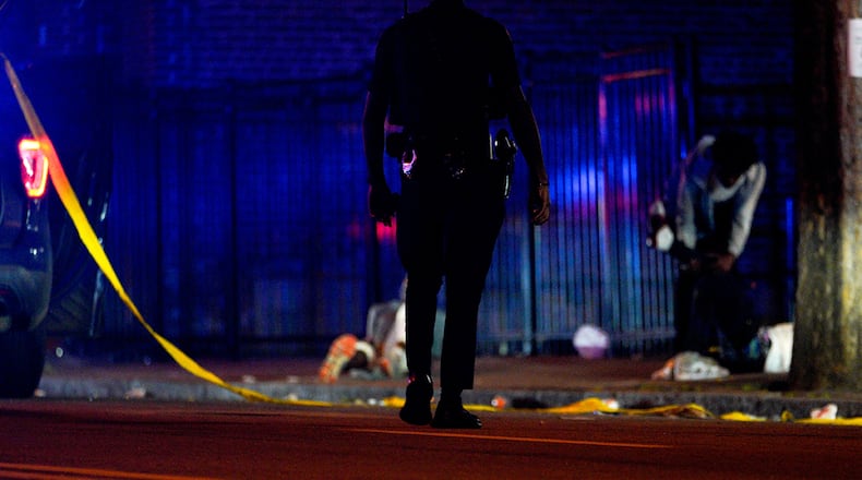 An Atlanta police officer checks a shooting scene on Martin Luther King Jr. Drive SW on Saturday, August 13, 2022. (Photo: Ben Hendren for The Atlanta Journal-Constitution)