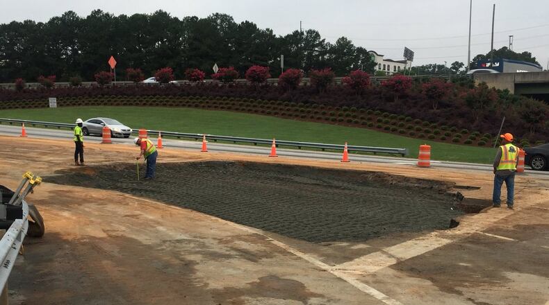 Crews are trying to repair an I-285 off-ramp in Cobb County that was damaged by a sinkhole.