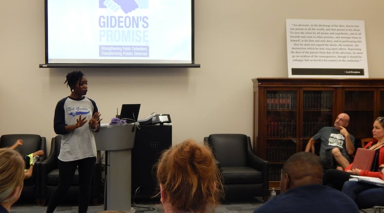 Ilham Askia (standing left) introduces herself to the Gideon’s Promise Class of 2016 by telling her story at the Summer Institute last year while her husband, Jonathan Rapping (right), listens. Askia left her job as a first-grade teacher to help her husband run the nonprofit. CONTRIBUTED BY GIDEON’S PROMISE