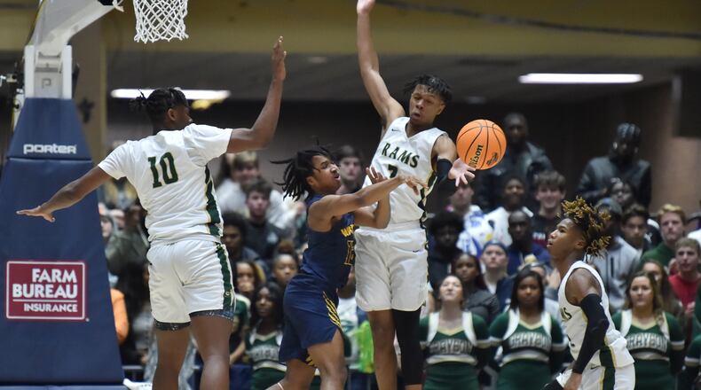 Wheeler's Juvon Gamory (12) gets off a pass against Grayson's Josh Smith (right) during 2020 GHSA State Basketball Class Championship game at the Macon Centreplex in Macon on Saturday, March 7, 2020. Westlake won 72-53 over Collins Hill. (Hyosub Shin / Hyosub.Shin@ajc.com)