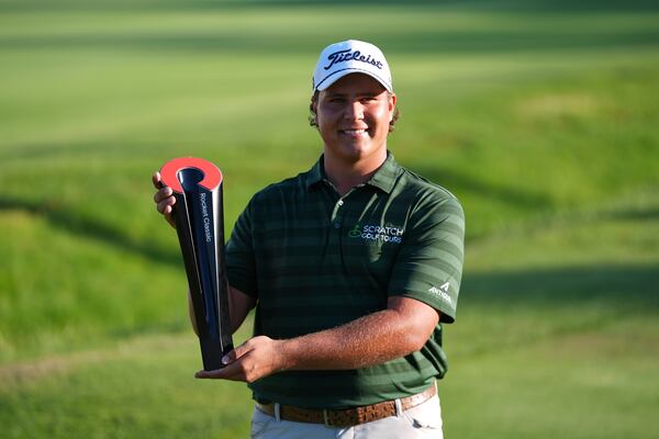 Aldrich Potgieter, of South Africa poses with the trophy after winning a playoff during the final round of the Rocket Classic golf tournament at the Detroit Golf Club, Sunday, June 29, 2025, in Detroit. (AP Photo/Paul Sancya)