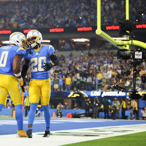 Los Angeles Chargers cornerback Cam Hart (20) and linebacker Daiyan Henley (0) celebrate after breaking up a touchdown pass during the second half of an NFL football game against the Pittsburgh Steelers Sunday, Nov. 9, 2025, in Inglewood, Calif. (AP Photo/Jessie Alcheh)