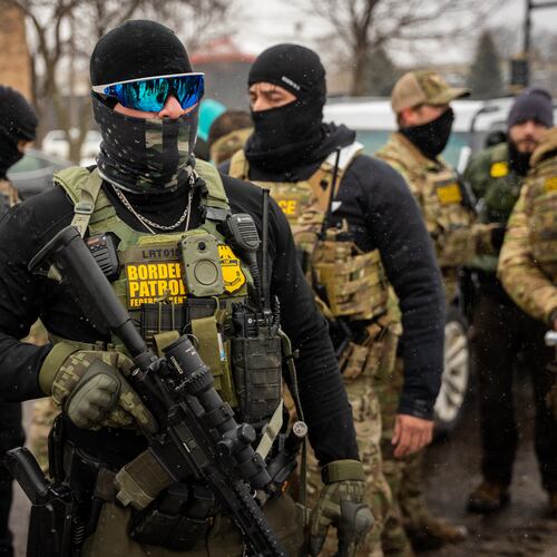 Federal agents stand guard, Wednesday, Jan. 21, 2026, in Minneapolis. (AP Photo/Angelina Katsanis)