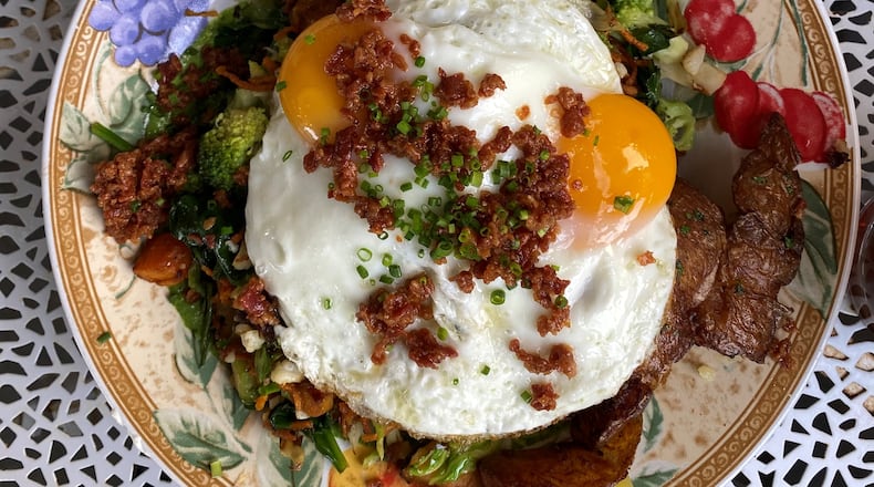 Hen Mother Cookhouse’s market hash packs in all kinds of good veggies, bacon crunch and two eggs, any way but poached. Wendell Brock for The Atlanta Journal-Constitution