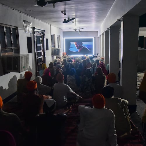 Villagers watch a special screening of the film “Satluj” at a Sikh temple at Tatley village, in Punjab's Gurdaspur district, India, Wednesday, July 8, 2026. (AP Photo/Prabhjot Gill)
