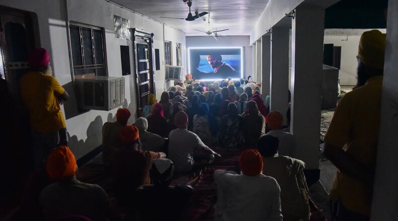 Villagers watch a special screening of the film “Satluj” at a Sikh temple at Tatley village, in Punjab's Gurdaspur district, India, Wednesday, July 8, 2026. (AP Photo/Prabhjot Gill)