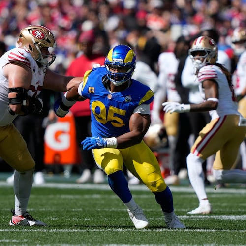 FILE - Los Angeles Rams defensive end Myles Garrett (95) tries to get past San Francisco 49ers offensive tackle Colton McKivitz, left, in the first half of an NFL football game in Melbourne, Australia, on Sept. 11, 2026. (AP Photo/Doug Benc, File)