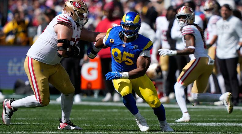 FILE - Los Angeles Rams defensive end Myles Garrett (95) tries to get past San Francisco 49ers offensive tackle Colton McKivitz, left, in the first half of an NFL football game in Melbourne, Australia, on Sept. 11, 2026. (AP Photo/Doug Benc, File)