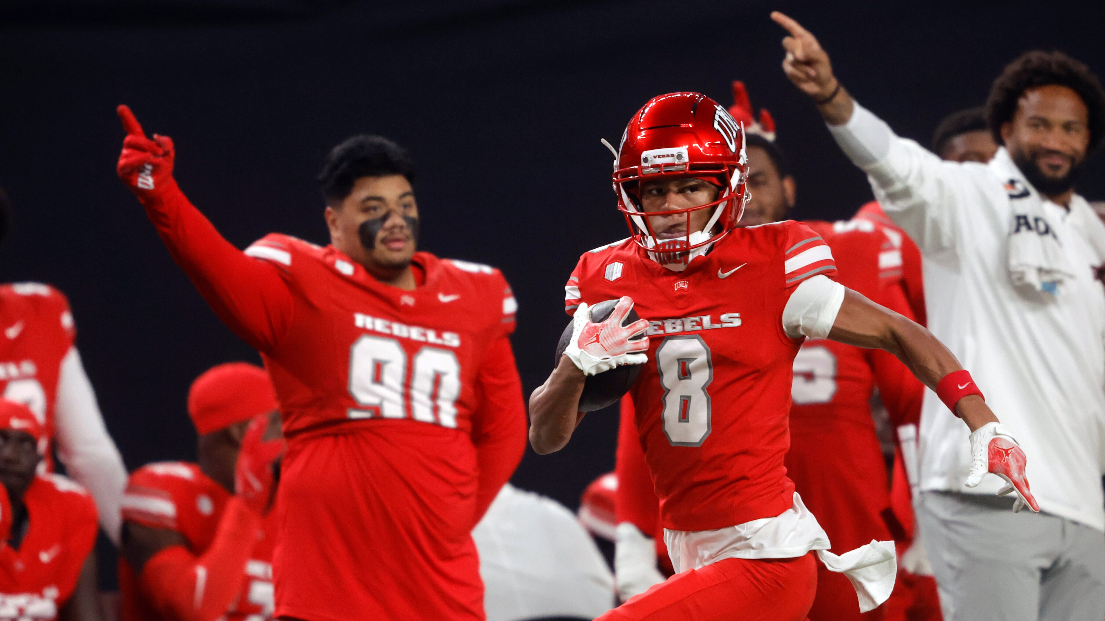 UNLV wide receiver Taeshaun Lyons (8) runs down the UNLV sideline for a touchdown after a pass reception during the first half of an NCAA college football game against Hawaii Friday, Nov. 21, 2025, in Las Vegas. (Steve Marcus/Las Vegas Sun via AP)