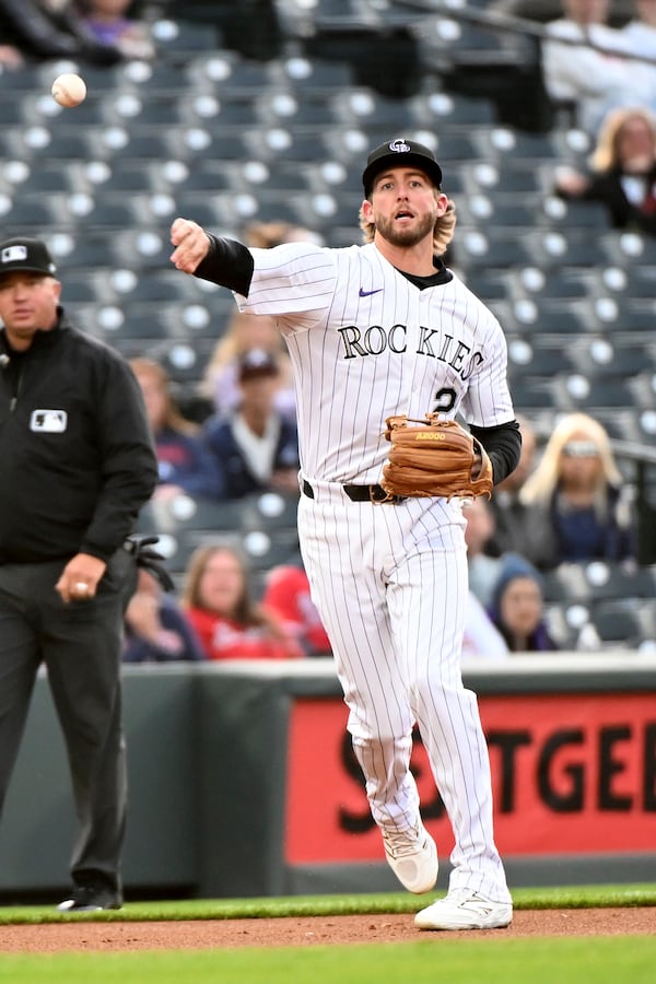 Colorado Rockies third baseman Ryan McMahon (24) throws to first base for an out in the first inning of a baseball game against the Atlanta Braves, Tuesday, April 29, 2025, in Denver. (AP Photo/Geneva Heffernan)